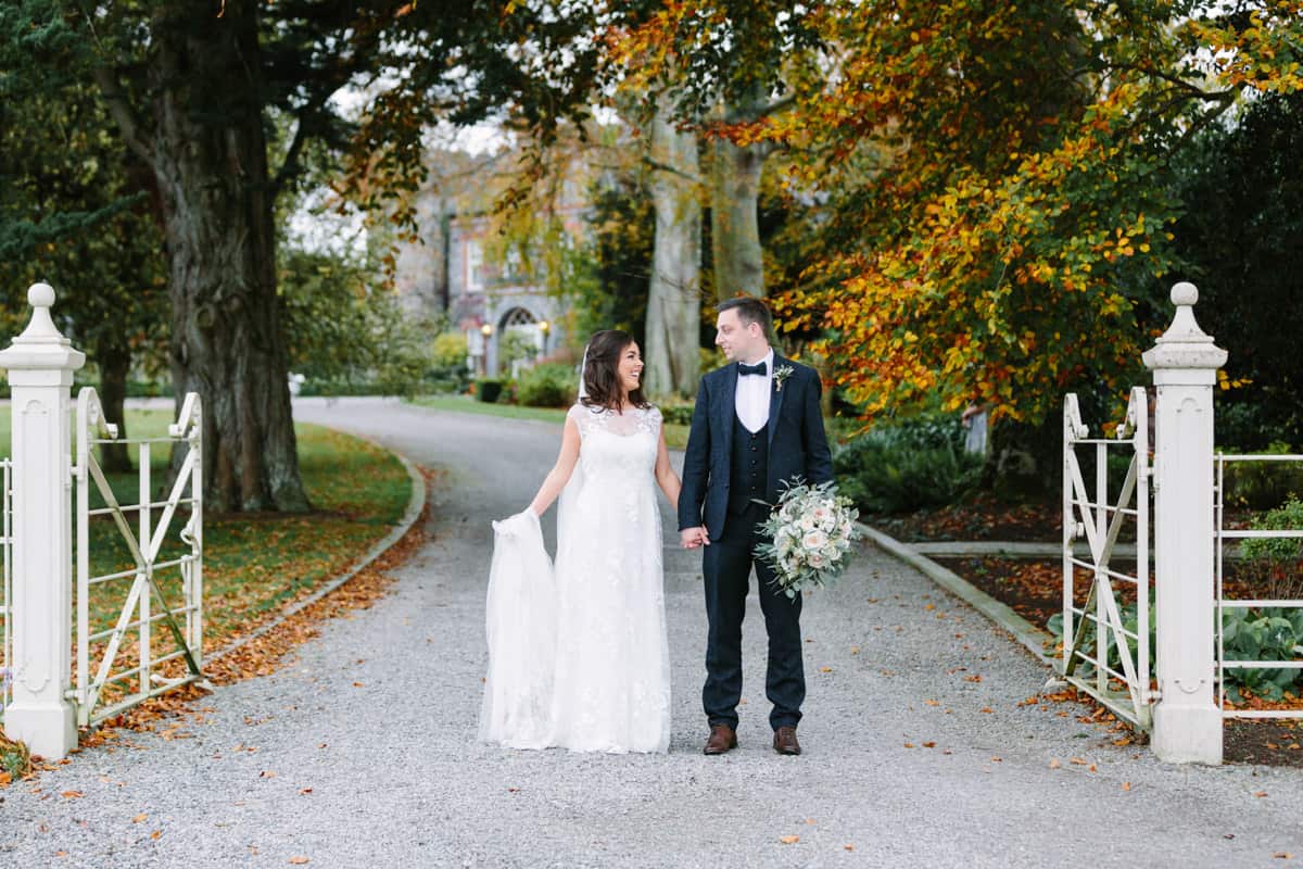 Bride and groom walking at Ballymagarvey Village