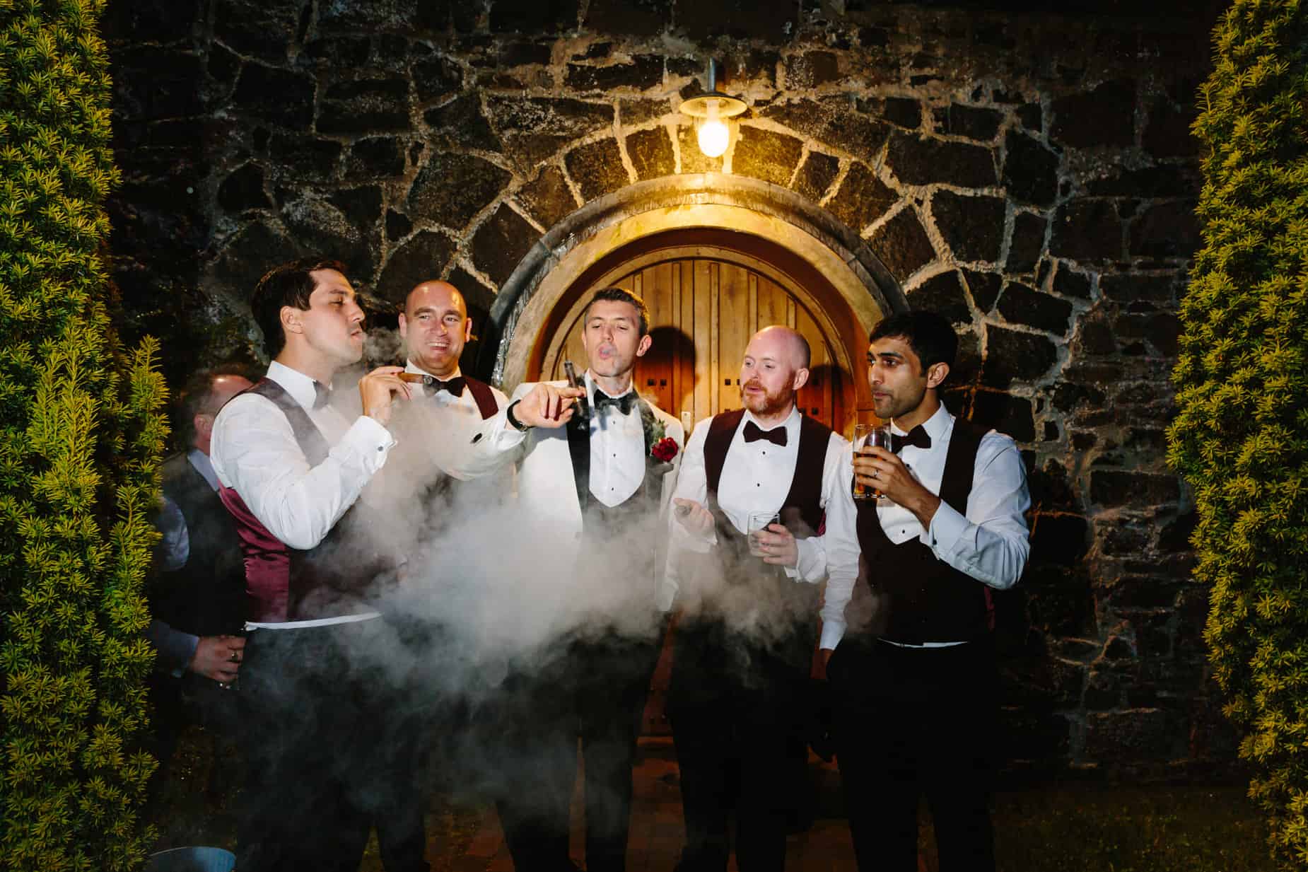 groom and groomsmen smoking cigars